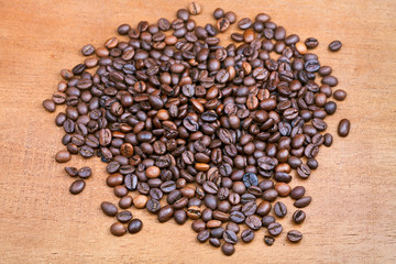 roasted coffee beans on wood plank