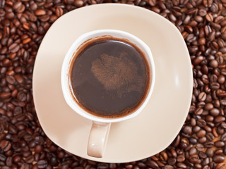 cup of coffee and roasted beans