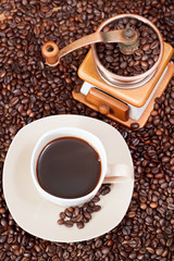 cup of coffee and roasted beans