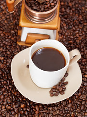 cup of coffee and roasted beans