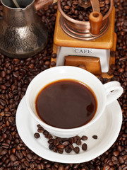 cup of coffee and roasted beans