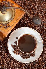 cup of coffee and roasted beans