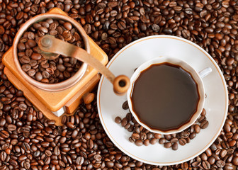 cup of coffee and roasted beans