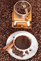 cup of coffee and roasted beans