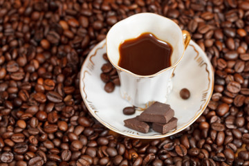 cup of coffee and roasted beans