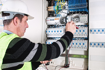 Electrician checking a fuse box - 59325481