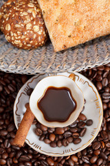 cup of coffee and roasted beans