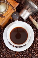 cup of coffee and roasted beans