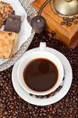 cup of coffee and roasted beans