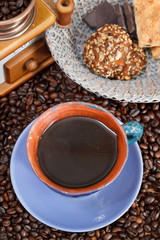 cup of coffee and roasted beans