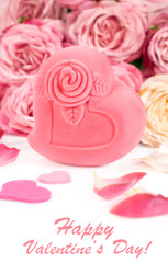 Gift box in heart shape with roses and petals