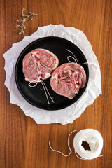 Raw lamb with rosemary on a frying pan