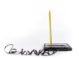 retro cassette with loose tape over a white background