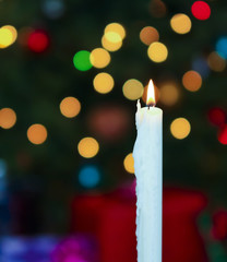 A White Christmas Candle with Blurred Lights