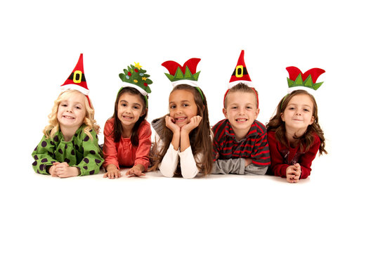 Five Children In Silly Christmas Hats Laying Down