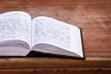 Jewish praying book on table.