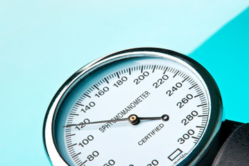 Sphygmomanometer on blue, reflective background