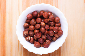 Plate with tasty nuts on the table