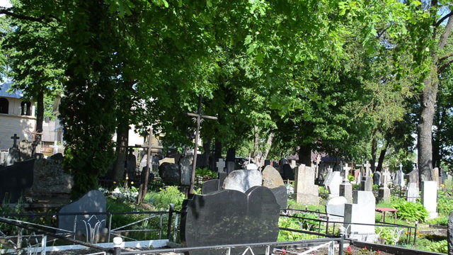 gravestones and crosses on graves in rural cemetery