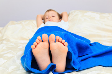 little boy foot sleeping at home, home comfort