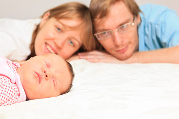 Obraz na płótnie Canvas happy family enjoying time with newborn daughter