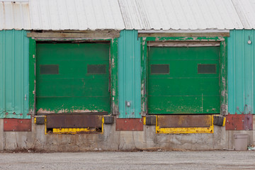 Two green shuttered outside loading gate ramps