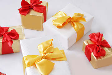 Gift boxes with golden and red ribbon