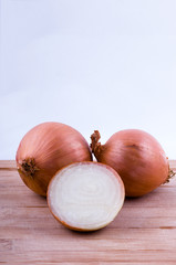 two full and one half onion on chopping board vertical