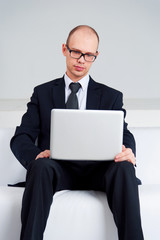 Businessman sitting with laptop