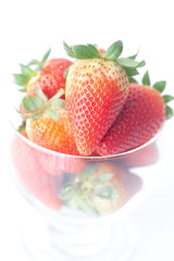 big red strawberries in a glass bowl