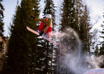 Fototapeta na wymiar Snowboarder jumping