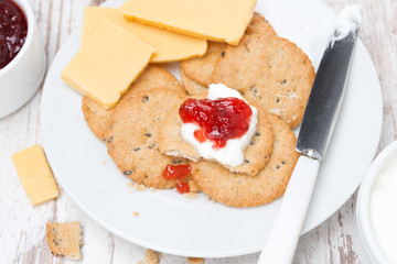 crackers with cream cheese and berry jam for breakfast, close-up