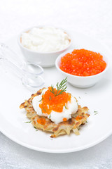 potato pancakes with red caviar, vertical