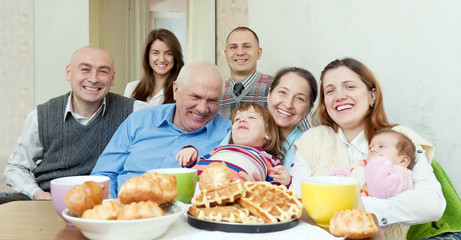  happy multigeneration family communicate around tea