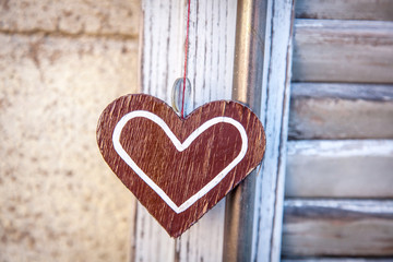 wooden heart  on a background of blue shutters