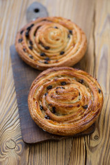 Freshly made crispy sweet roll buns, vertical shot