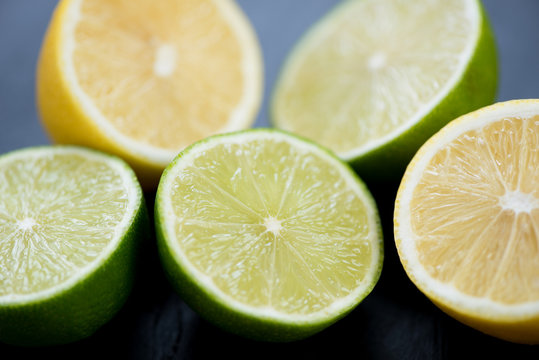 Ripe sliced limes and lemons, close-up, studio shot