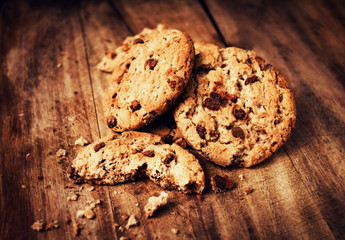 Stacked chocolate chip cookies on wooden table in rustic,  count