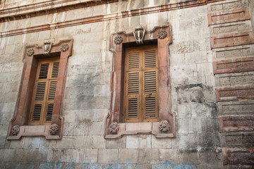 Fototapeta na wymiar Two old windows closed by shutters, Jerusalem