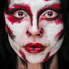 beautiful young girl with paint on his face