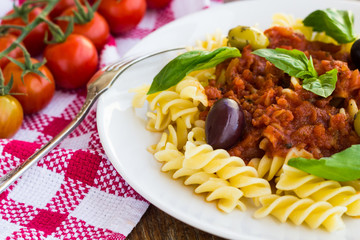 Pasta with tomato souse, olives and basil