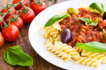 Pasta with tomato souse, olives and basil