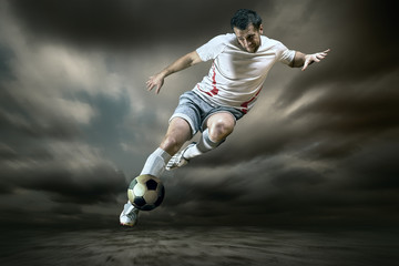 Obraz na płótnie Canvas Football player with ball on field of stadium