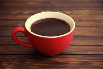 red cup coffee on wood background