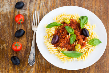 Pasta with tomato souse, olives and basil