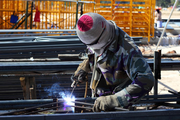 welder welding  steel on construction site