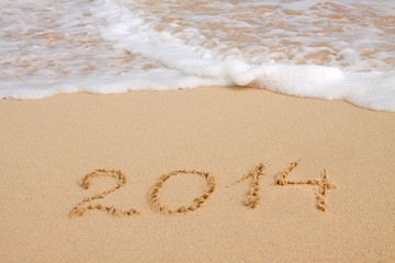  Year 2014 written in sand on tropical beach