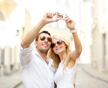travelling couple taking photo picture with camera