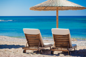 view of the beach with chairs and umbrellas