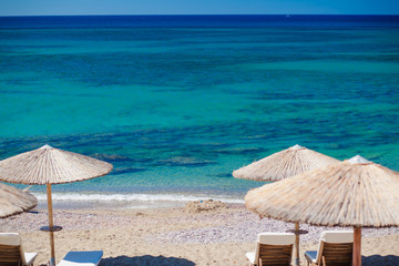 view of the beach with chairs and umbrellas